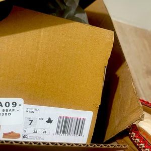 Extremely beautiful brand spanking new UGG Taz! soft suede with, red accents.